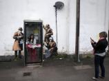 Banksy's Spy Booth work on the side of a house in Fairview Road, Cheltenham, before it was vandalised