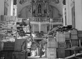 A U.S. soldier stands among thousands of artworks stolen by the Nazis and stored in a church at Elligen, Germany, during World War Two